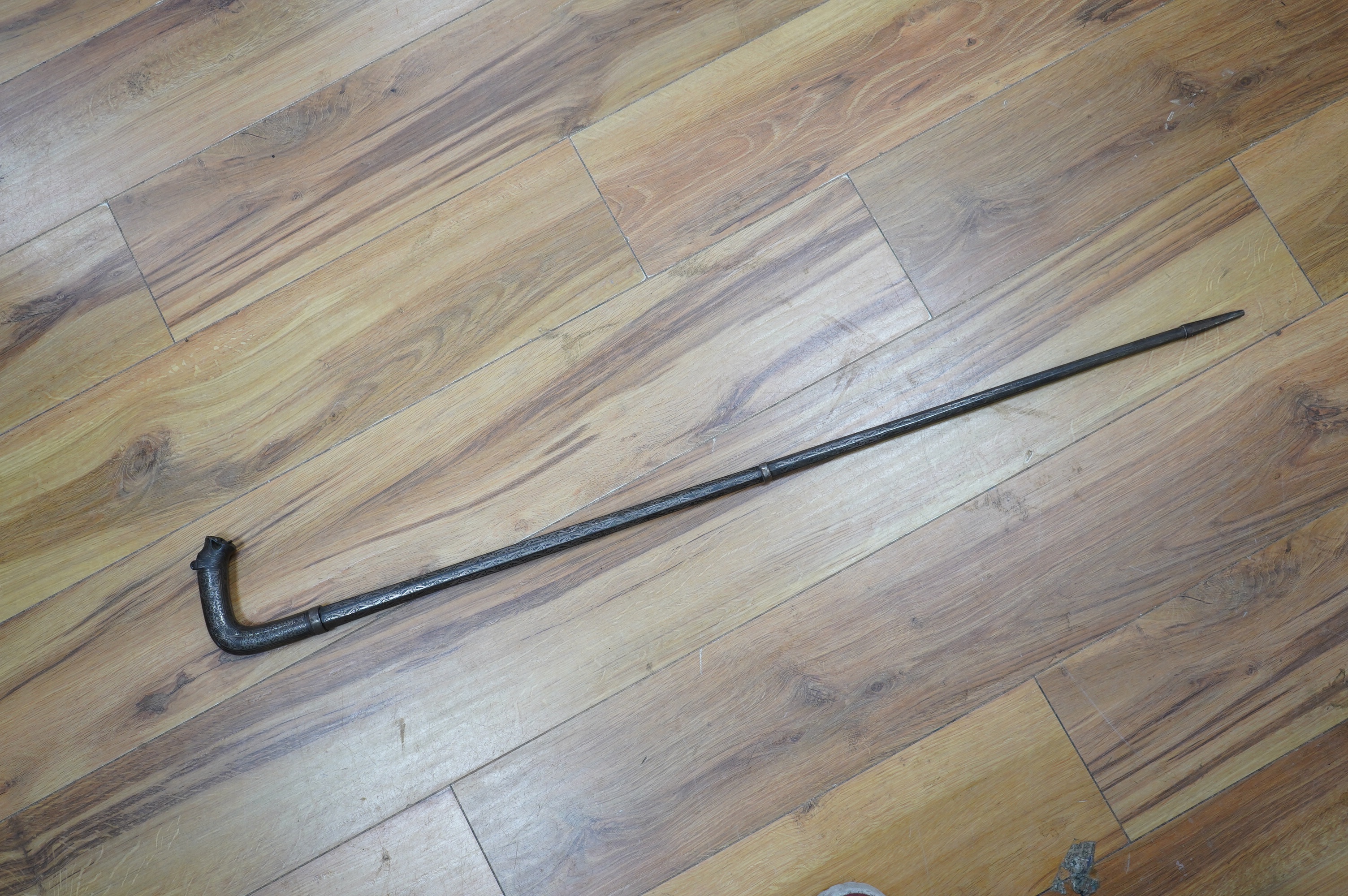 A 19th century Indian bidriware swordstick with stylised leopard handle, blade 14cm, overall length 97cm. Condition - fair to good, some surface wear.